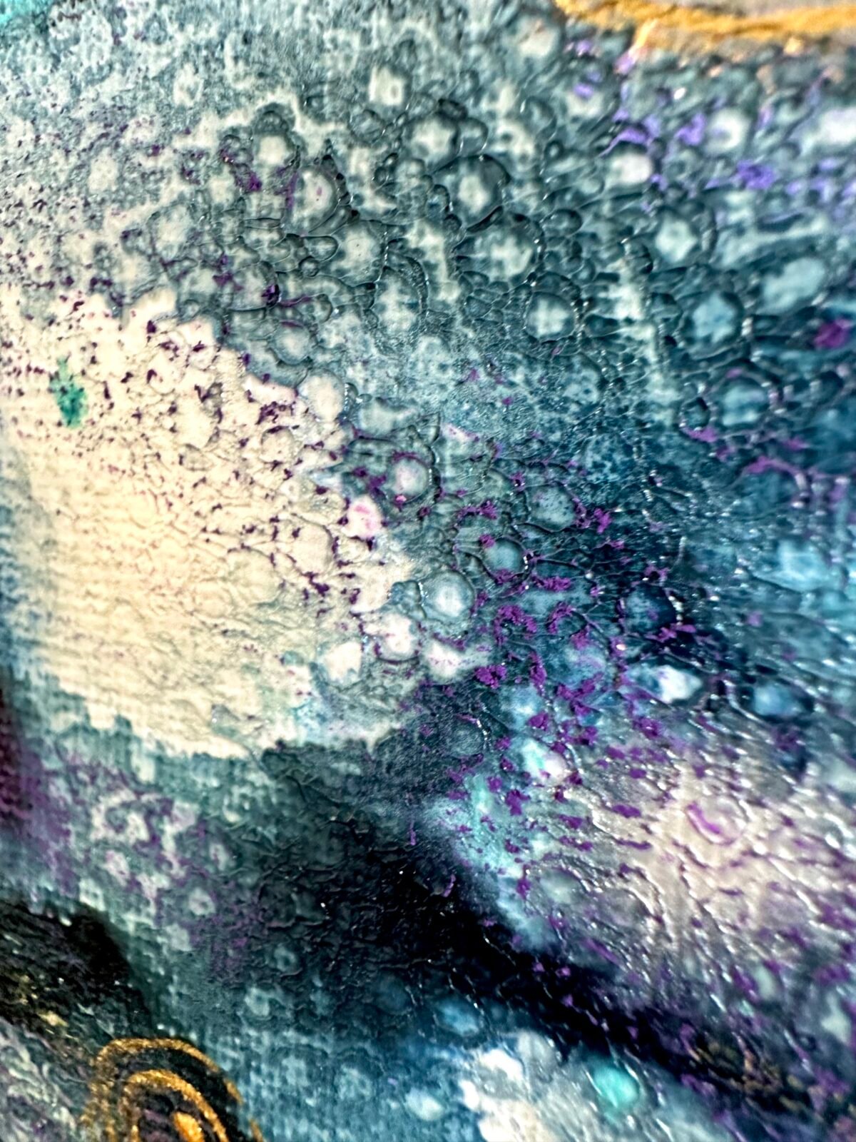 Close-up of layered blue-grey and purple bubble-like texture on canvas